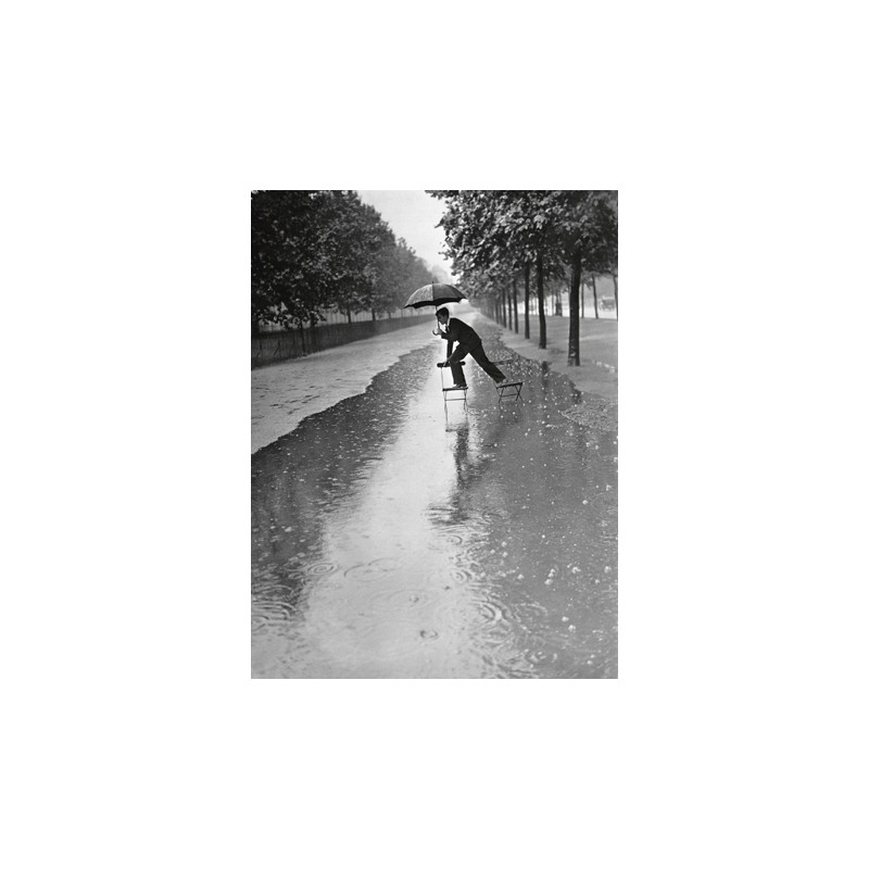 MAN CROSSING PUDDLE ON CHAIRS, 1934