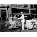 COUPLE ON MOTOR SCOOTER BUYING ICE CREAM BAR, 1954