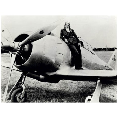 FEMALE PILOT STANDING ON AIRPLANE